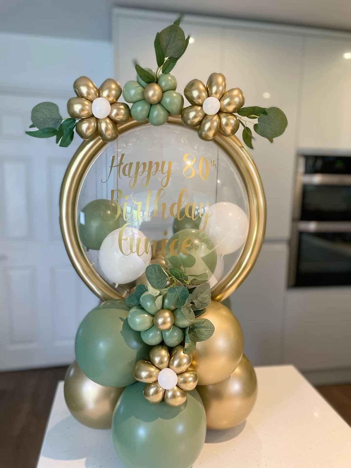 Statement Jovira balloon arch backdrop framed by two styled photo moments