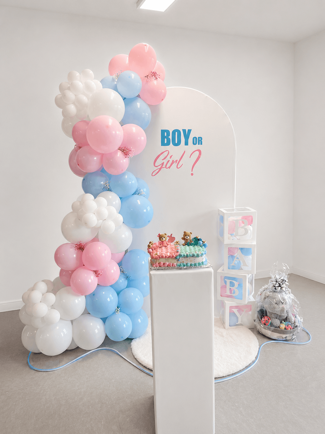 Graduation celebration with statement signage, caps, and coordinated cream and gold balloons