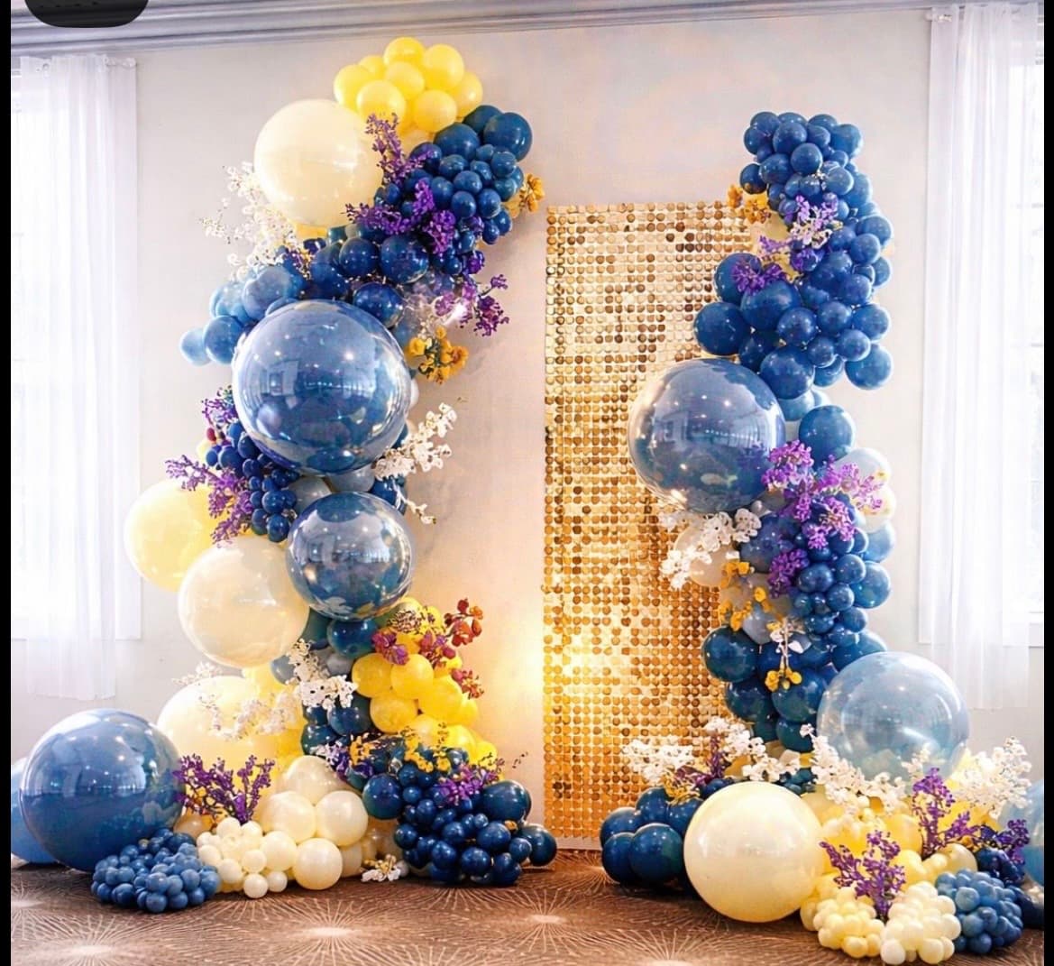 Full-scale Jovira transformation with an entrance arch, photo wall, and multiple styled zones