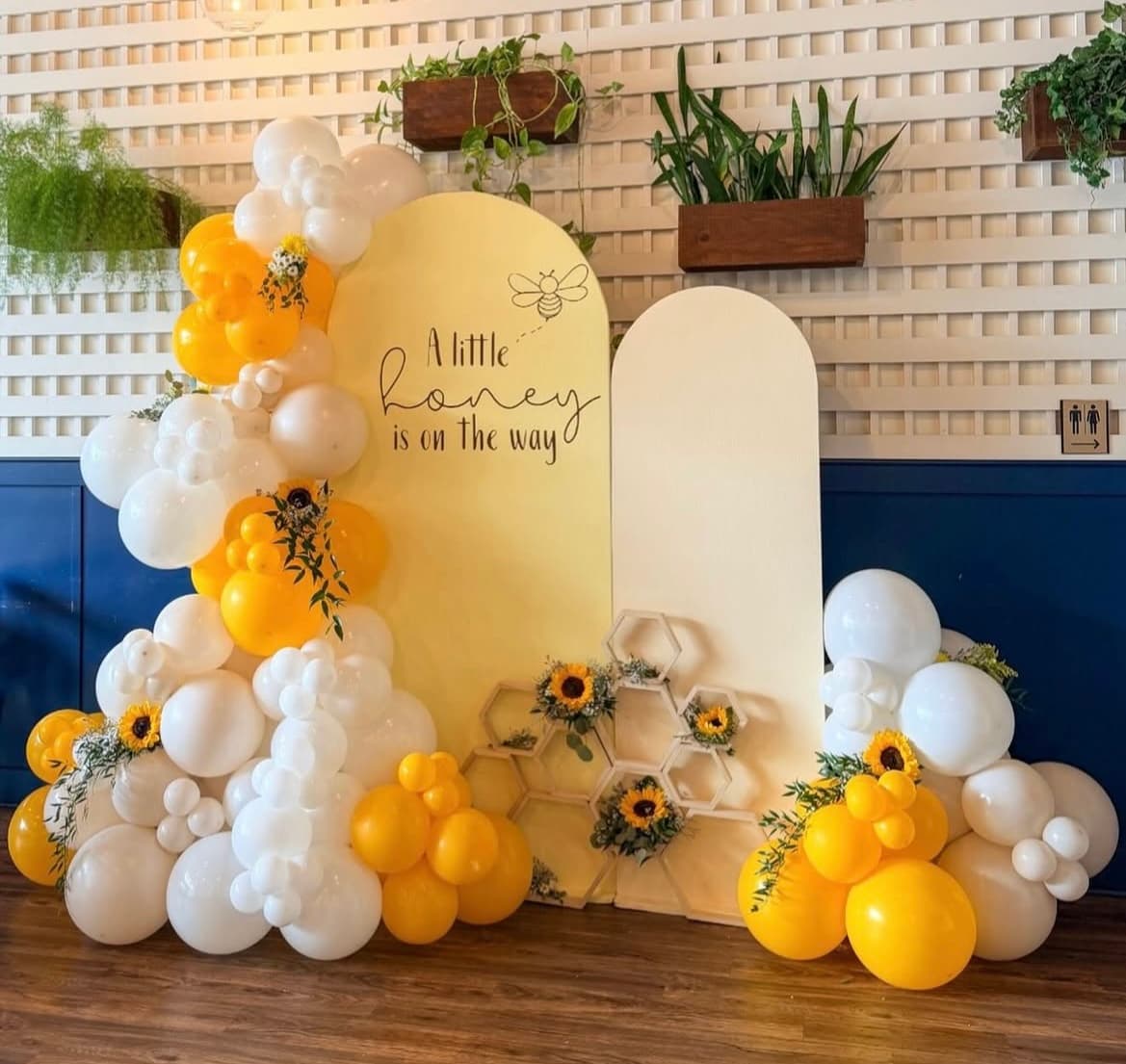 Statement Jovira balloon arch backdrop framed by two styled photo moments